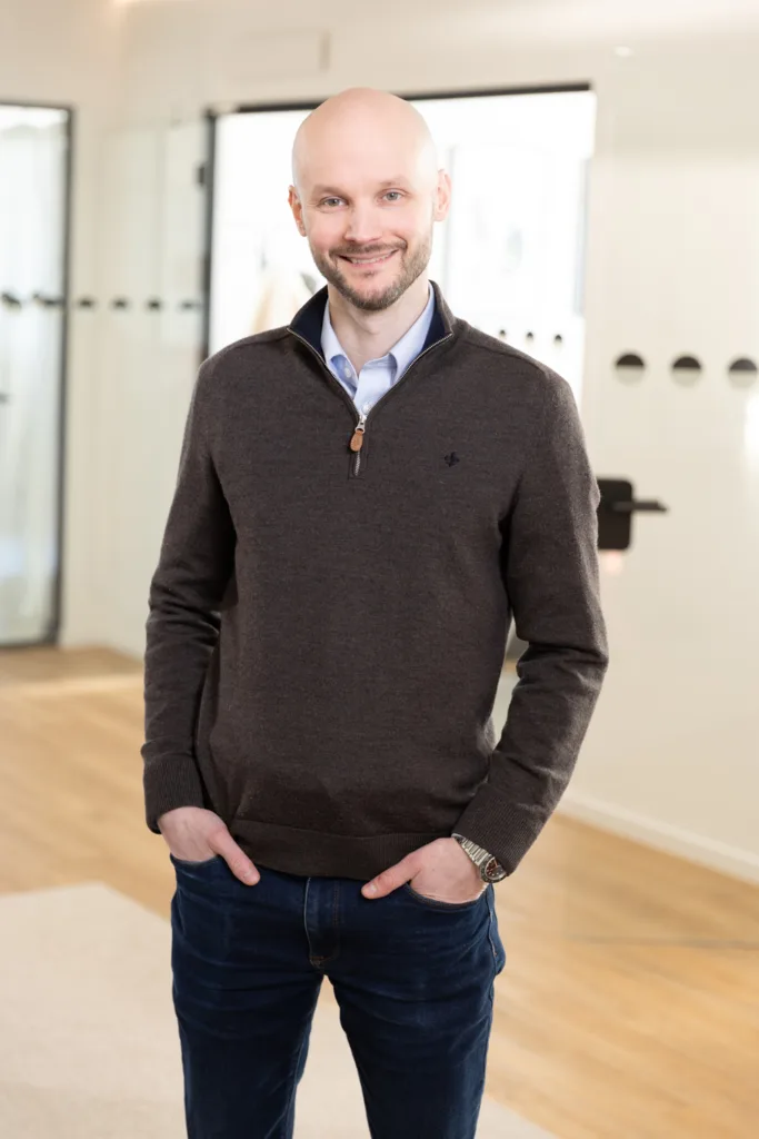 Portrait of a team member, photographed in a professional office environment.