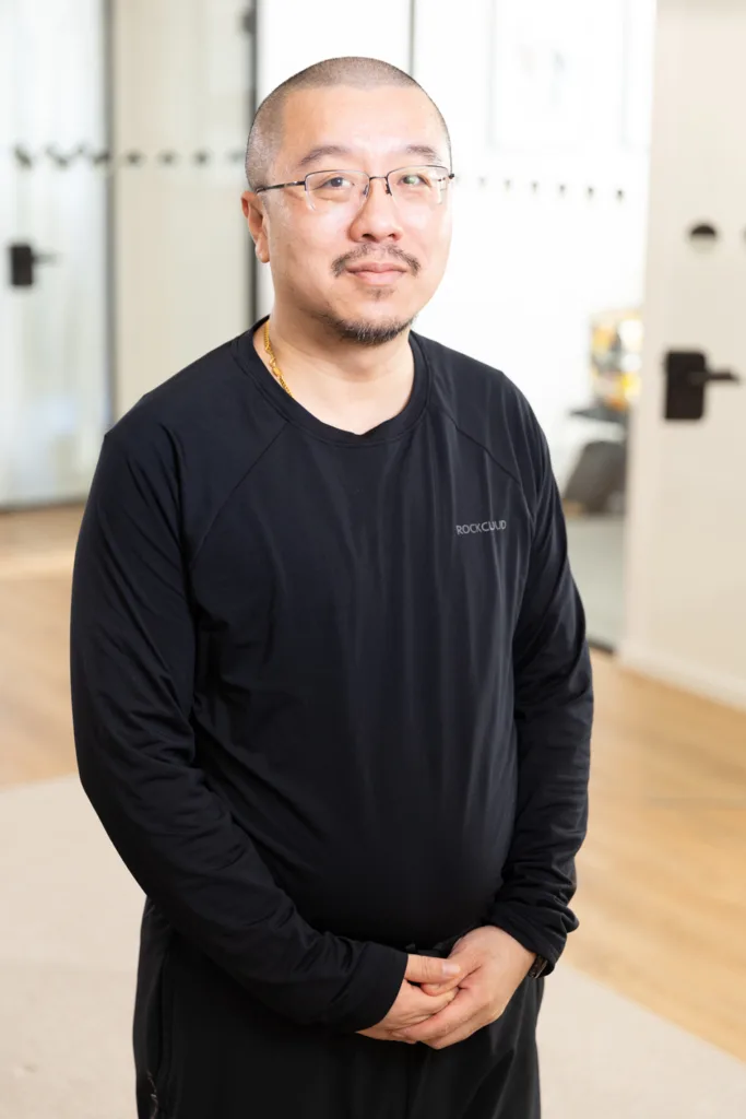 Portrait of a team member, photographed in a professional office environment.