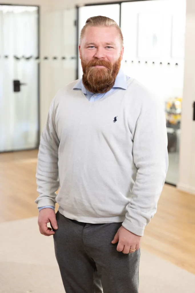 Portrait of a team member, photographed in a professional office environment.