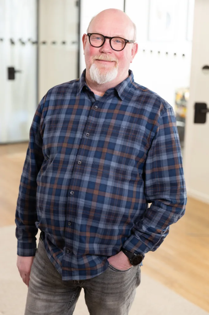Portrait of a team member, photographed in a professional office environment.